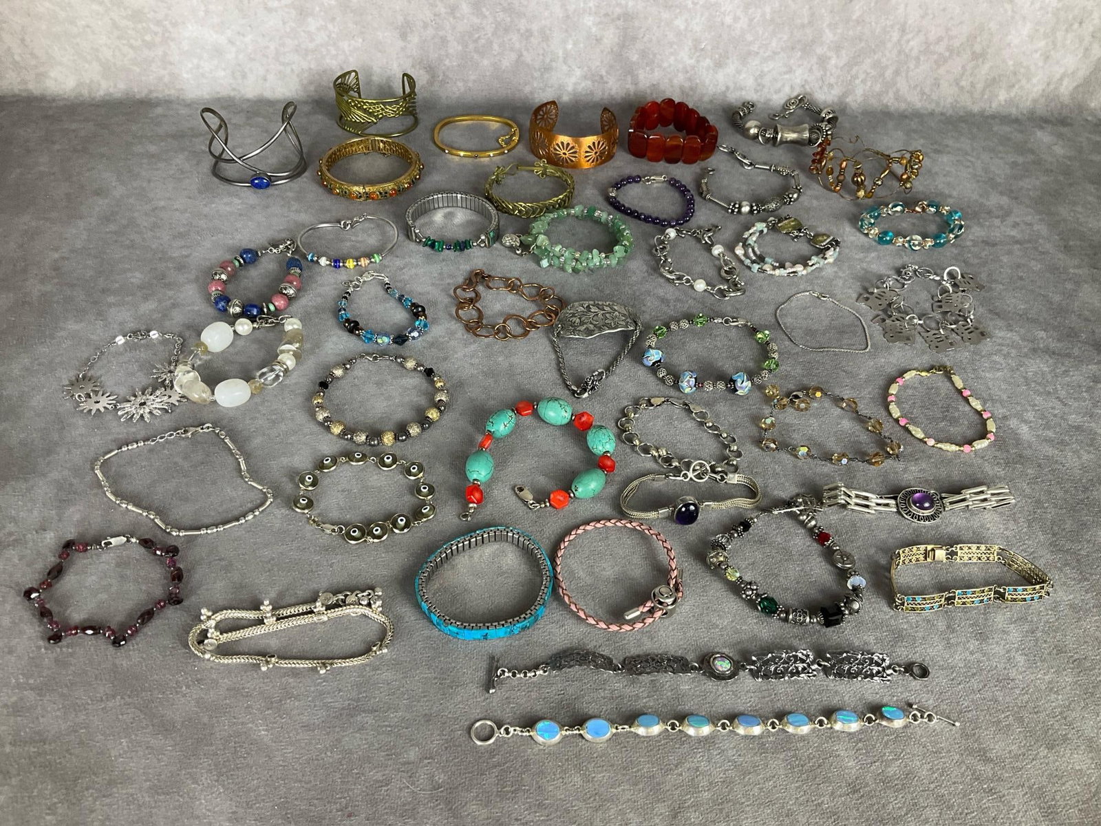 Bracelets: Cuff, bangle, and regular clasp bracelets. Several marked .925. Great variety of styles. Good condition.