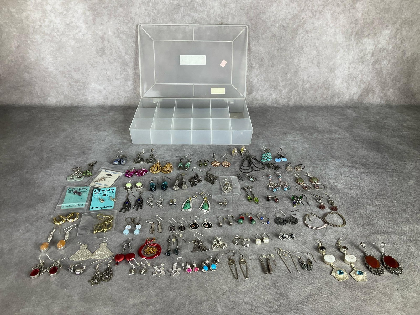Pierced Earrings: Post and fish hook. All have matches but not all have backs. Many marked .925. Includes plastic organizer. Good condition.