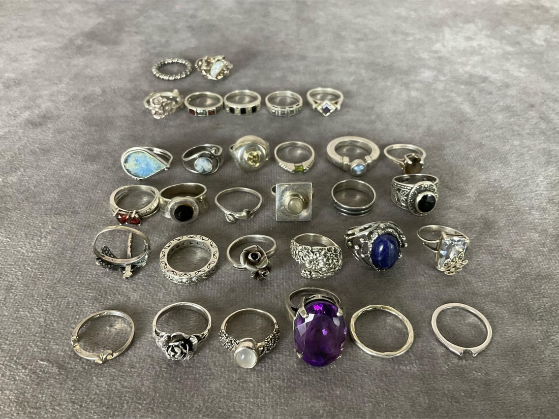 Sterling Silver Rings: Size 6 to 6.5. Total of 31. Two of the rings test as silver but are not marked. Four rings have damaged or missing stones. One has a split band. Others are in good condition. Marked .925 or sterling.
