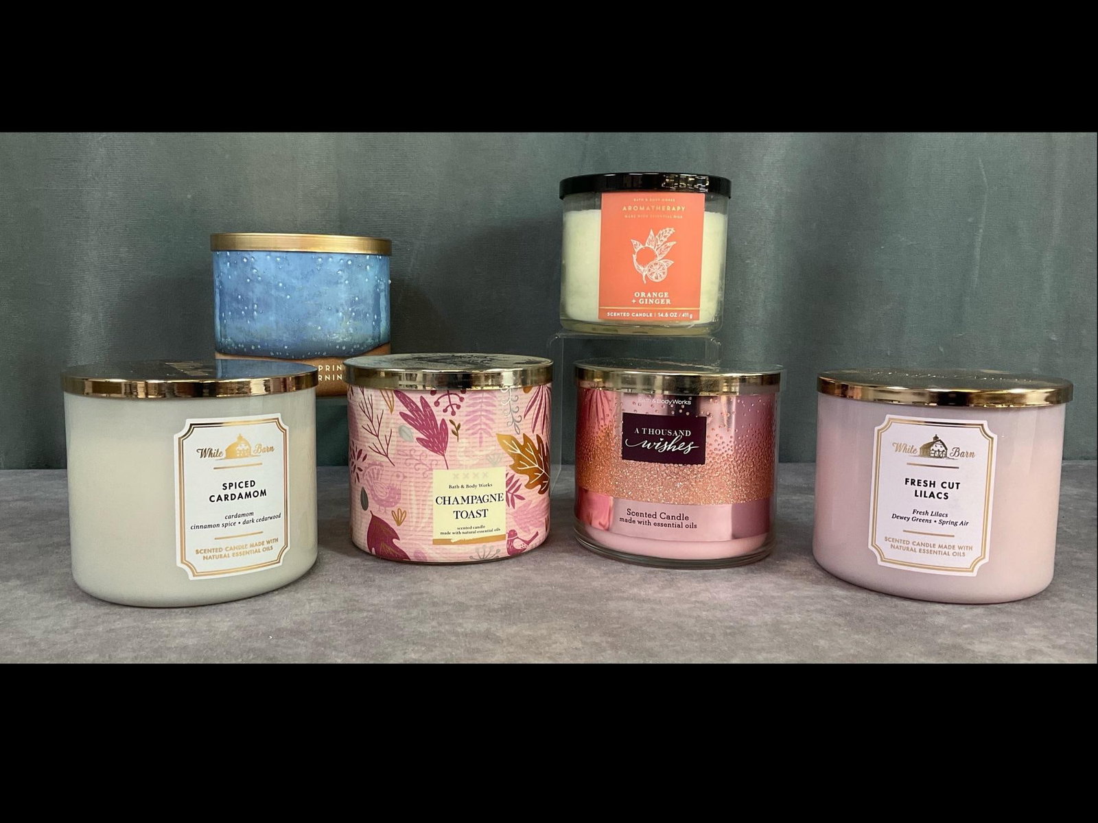 Aromatherapy and Essential Oils Candle Collection: Group of six. Includes three Bath and Body Works 14.5 ounce candles in glass jars with lids. Scents include A Thousand Wishes, Orange and Ginger and Champagne Toast. Three White Barn 14.5 ounce candle