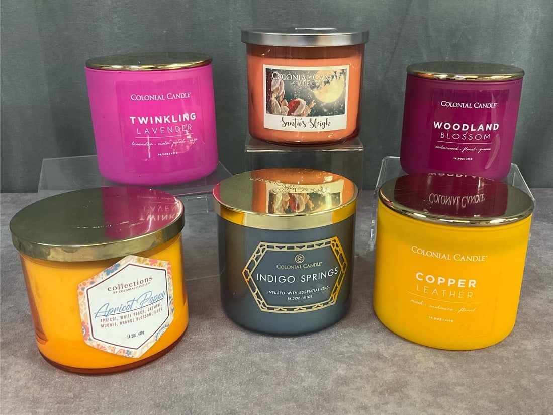 Colonial Candles: Group of six. All candles are 14.5 ounce candles in glass containers with metal lids. Scents are Santa's Sleigh, Mother's Day Apricot Poppy, Indigo Springs, Woodland Blossom, and Twinkling Lavender. A