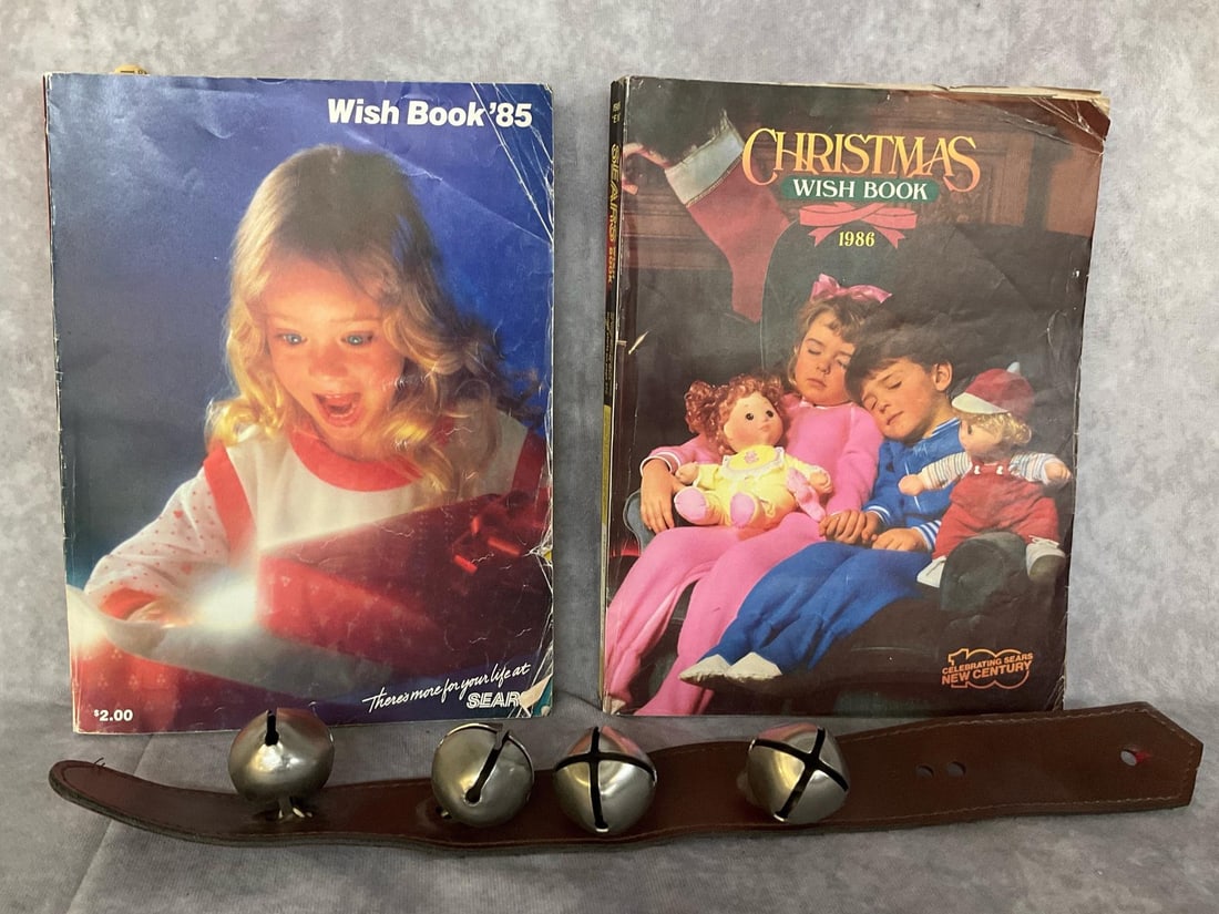 Sears Wish Books and Jingle Bells: 1985 and 1986 Sears Christmas Wishbooks. Well used but do not appear to have missing pages. Eighteen inch leather strap with four bells. Good condition.