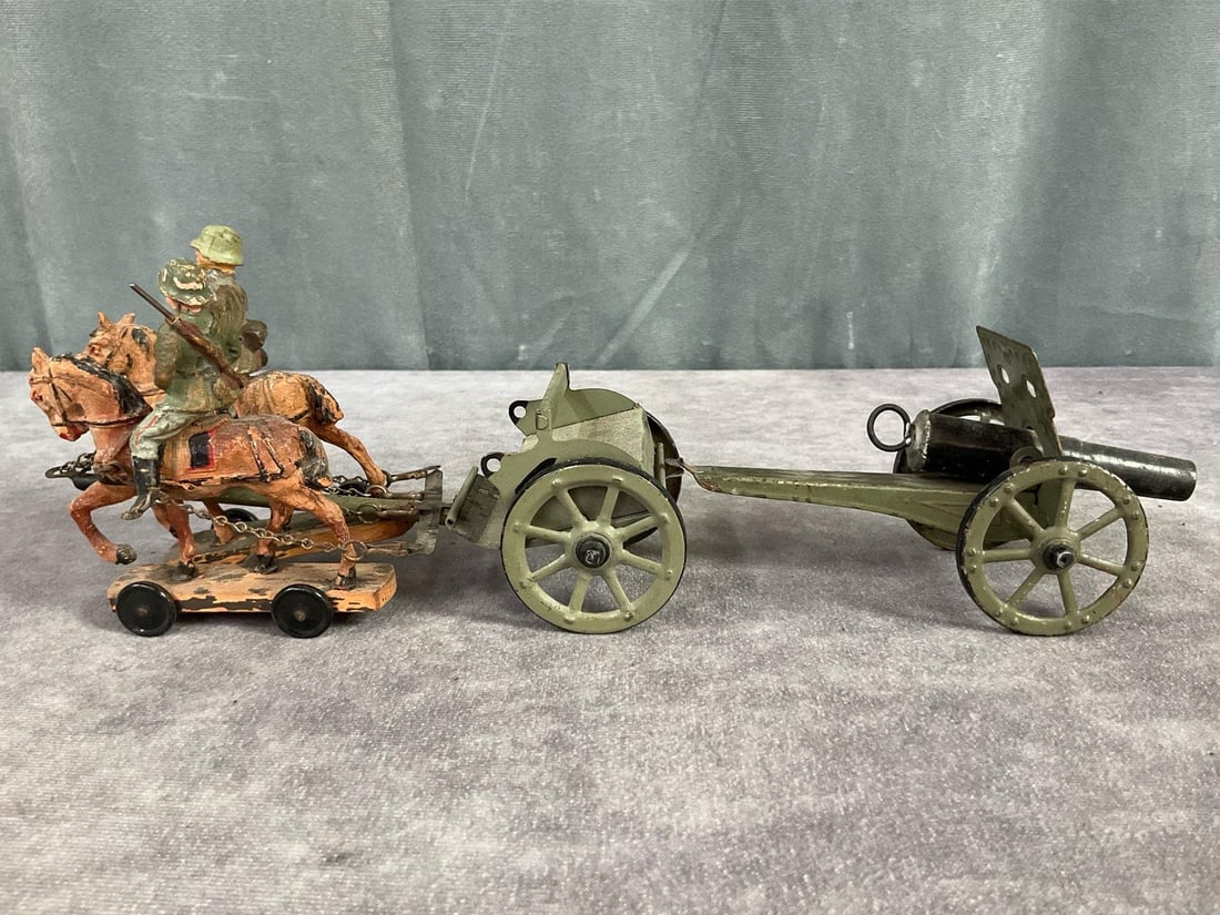 Hausser Horse Drawn Wagon With Cannon: Metal wagon and cannon, wagon marked Hausser Germany. Wood base composition horses and two soldiers. Not certain if all pieces are original to wagon. Horses and soldiers are in poor condition, cracks 