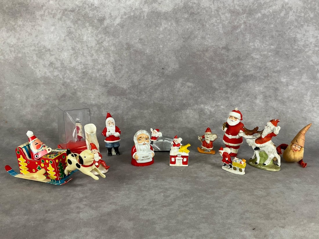 German & Japan Miniature Santas: Eleven total. All but one are ceramic, several stamped Germany. Tin Santa Dog pulling car tin toy in original box, untested. Fair to good condition, with paint loss, and scratches. Tin toy measures 6