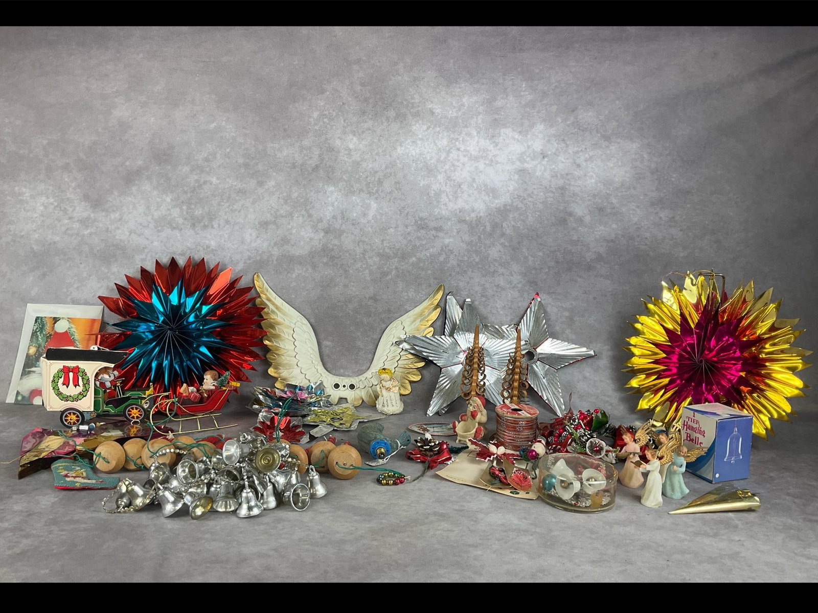 Miscellaneous Vintage Christmas: A large lot. Good for crafting, with a variety of ribbons, corsages, light reflectors, star toppers, wooden figures and much more. Fair to good condition. Tallest pinwheel measures 10 inches.
