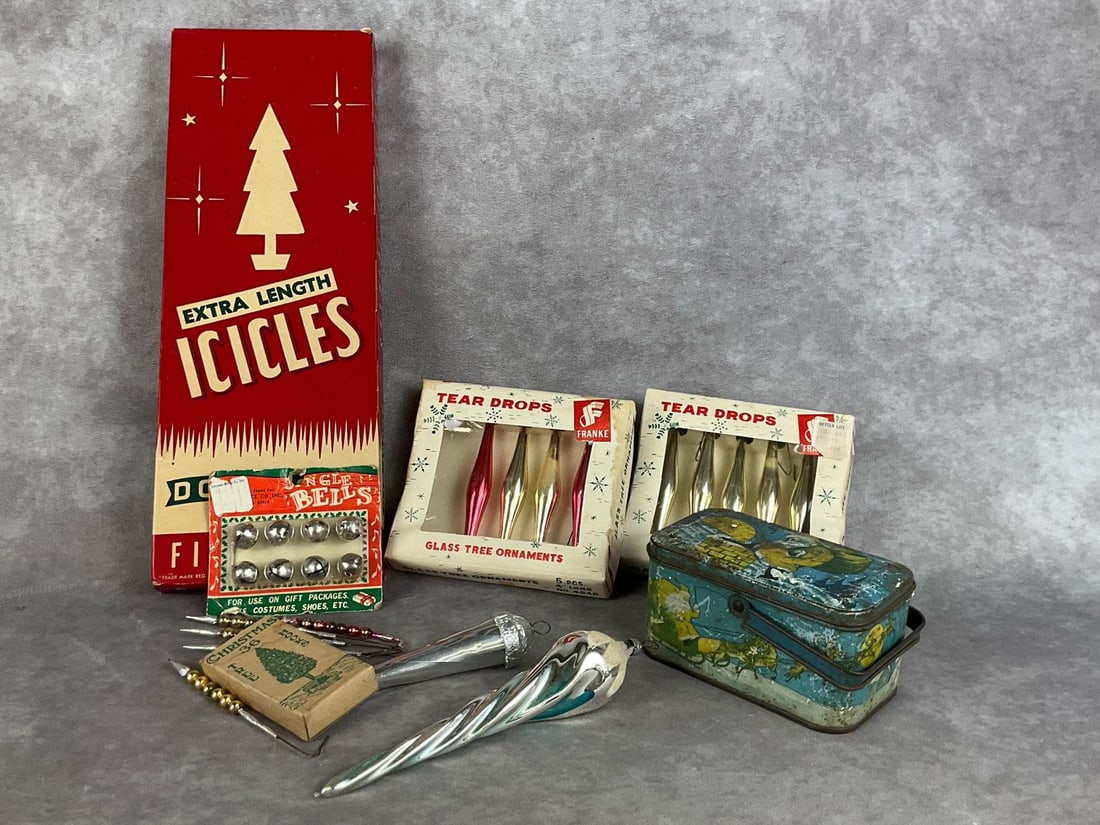Icicles, Bells & Teardrops: Fourteen pieces total. Extra length icicle tinsel in box, two boxes of teardrops, three teardrop ornaments. 1920s candy tin, jingle bells in original packaging, an empty box of Christmas tree hooks, a
