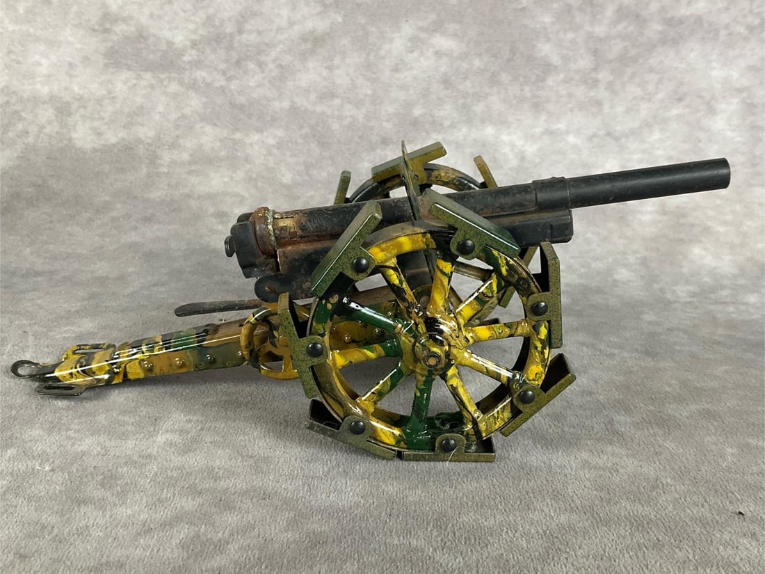 German Field Gun: 1940s. Believed to be Marklin, but has been repainted. Barrel has rust and wear. Fair condition. Measures 9 inches wide x 3.5 x 3 inches high.