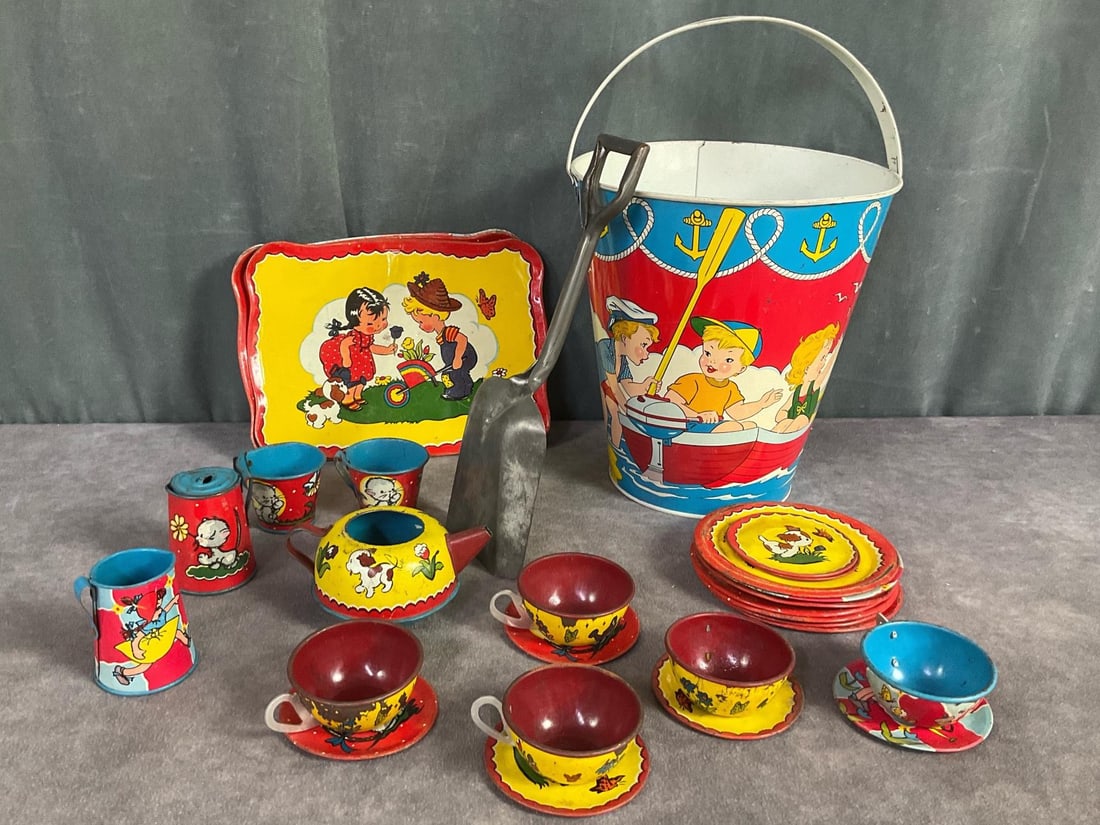 Ohio Art Children's Beach and Tea Set: 1950's Metal Sandbucket and shovel. Bucket is 10.5 inches to top of handle. Good condition for age with bright colors and light scratching. Tin litho tea set which includes three 7.5 x 5.5 inch platte