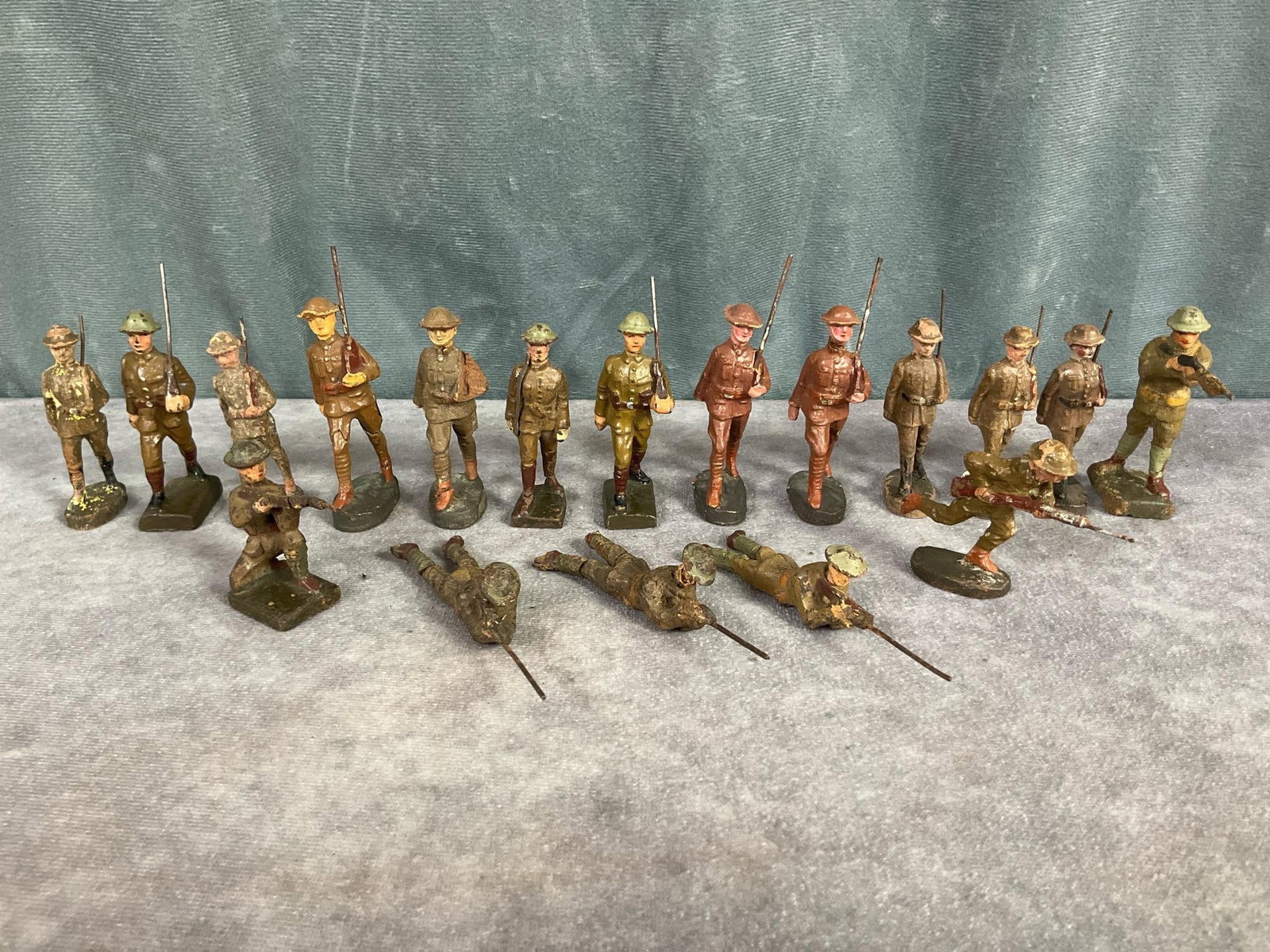 1930's Elastolin Soldiers: Eighteen marching and shooting German, American, and British soldiers marked Elastolin, Lineol, and Duro. Cracking, paint loss, repainted, measure 3 inches tall.
