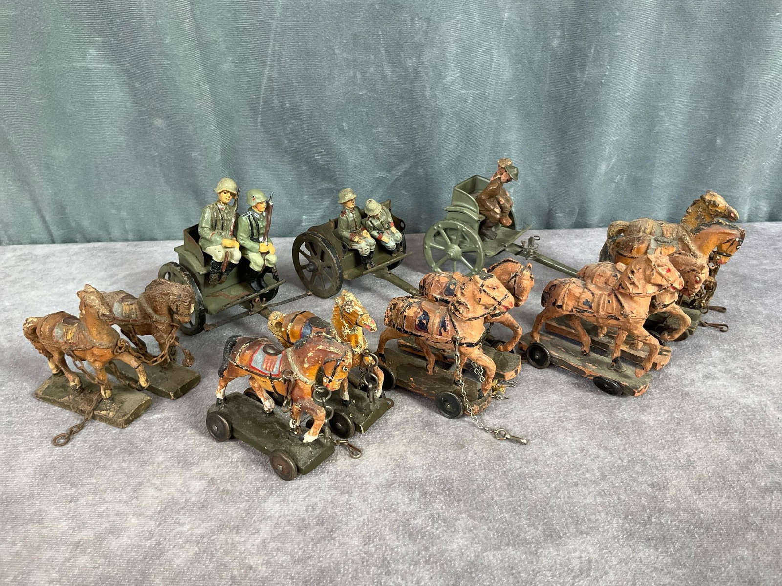 1930's Elastolin Horse Drawn Caissons: Three metal unmarked caissons most likely Hausser Germany, five pairs of horses, and six soldiers. Horses marked Lineol and unmarked. Cracking, paint loss, repainted, and broken legs. Caissons measure