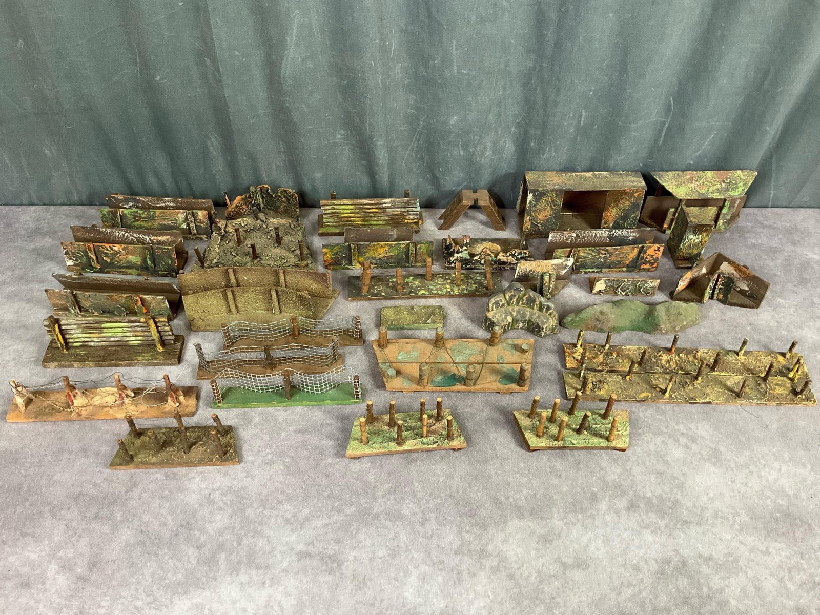Large Lot of German Trench & Fencing Pieces: Some Elastolin pieces, others unmarked, made of wood and composite. Overall good condition, some wires are loose on fences. Longest piece measures 13 inches long.