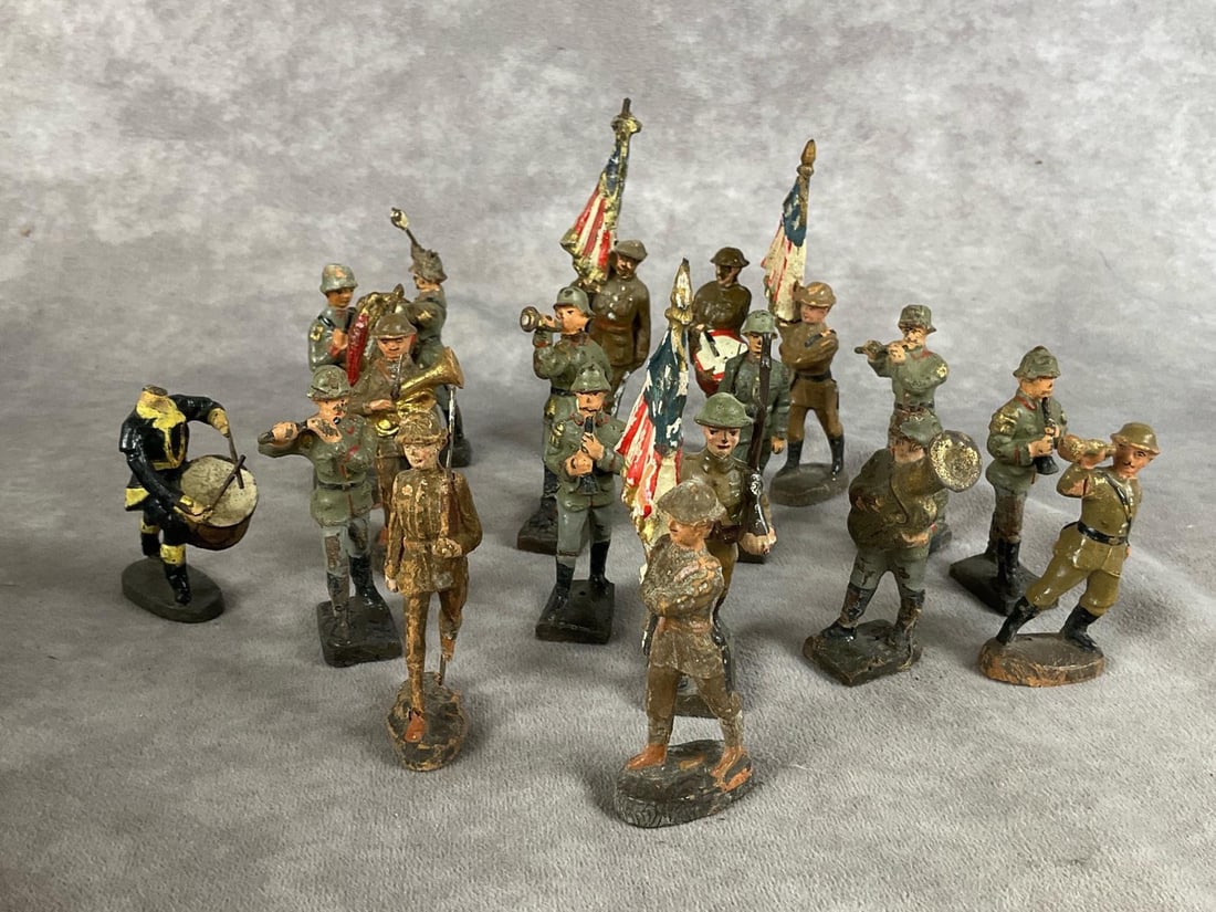 Elastolin Marching Band: Group of eighteen. Marked Elastolin, Lineol and Japan. All have paint loss, cracking, and missing pieces. Tallest is 4 inches.