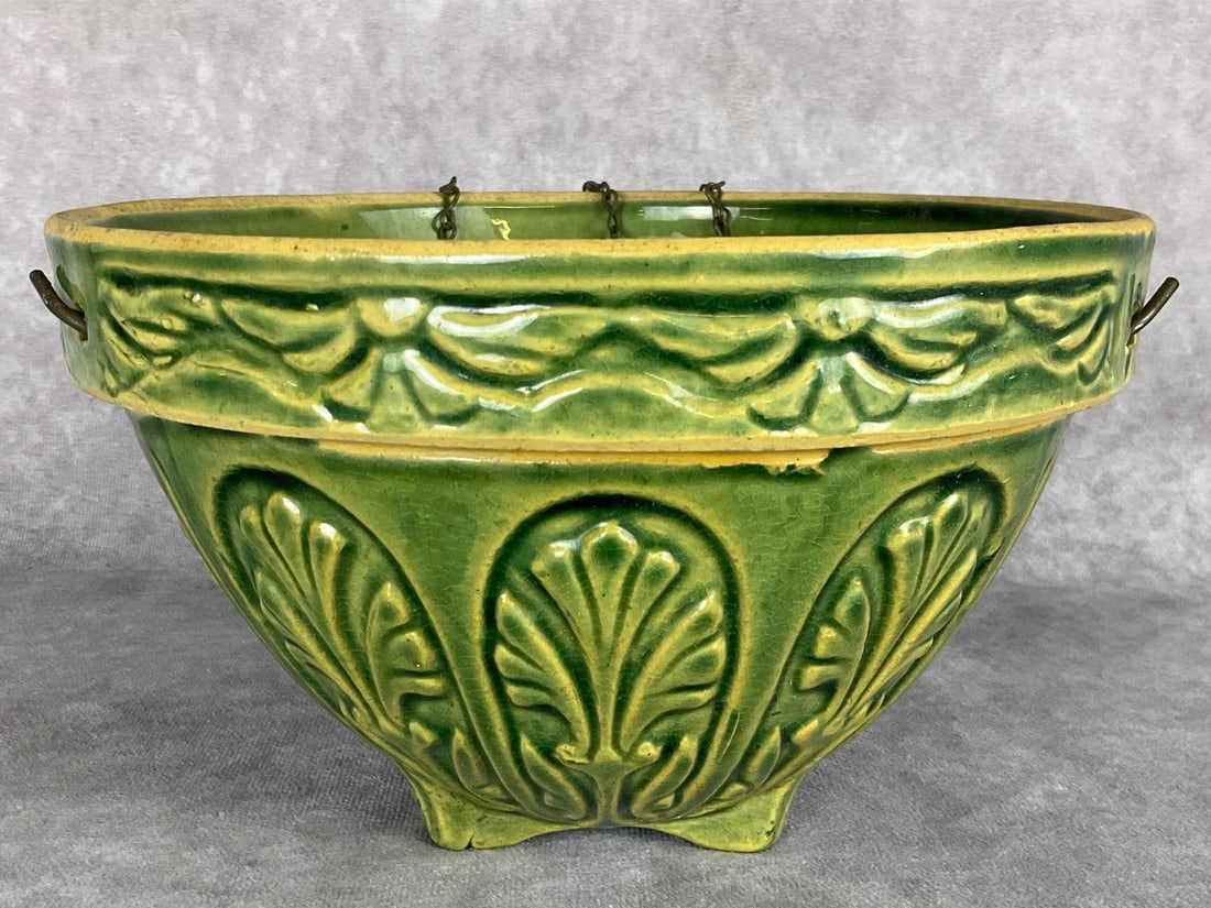 McCoy Green Glazed Hanging Planter: With a three hook chain. Unmarked but attributed to McCoy. Crazing throughout. 8 inches at the widest x 5 inches tall.