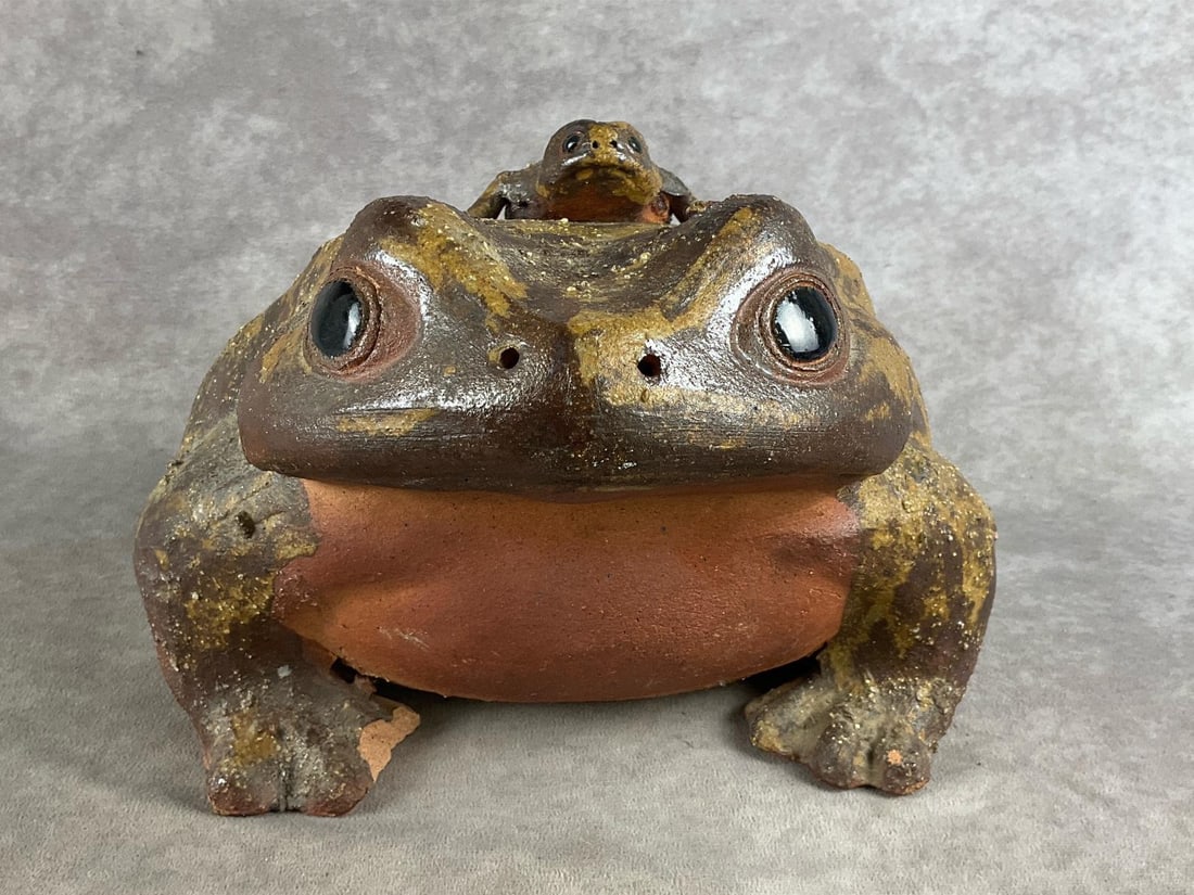 Japanese Shigaraki Ceramic Frog: Handmade ceramic frog that is said to represent greeting and returning successfully. Large in size and heavy. Right foot is damaged. Measures 10 inches wide x 8 inches high x 13 inches long.
