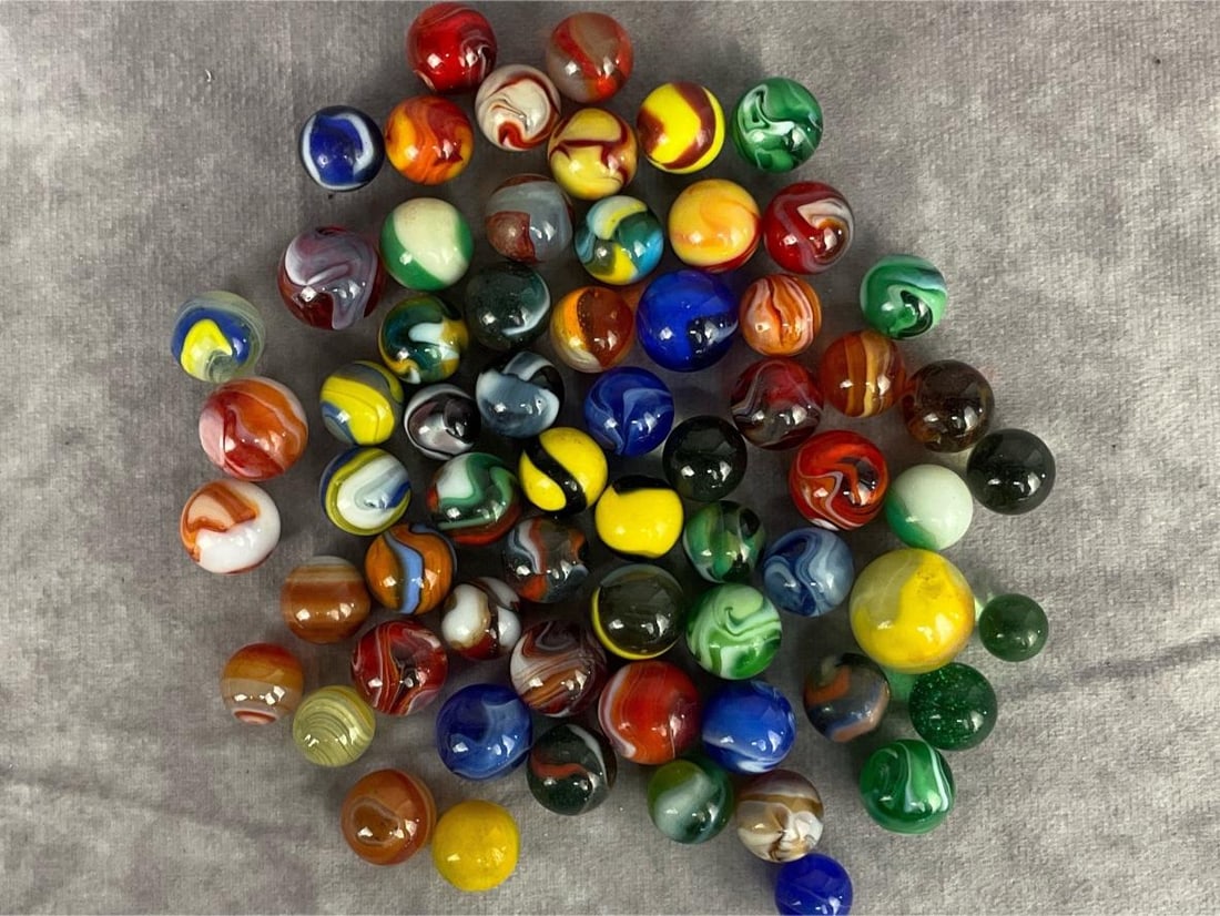 Early 1900's Marbles: Collection of 62 older marbles in good condition, some marbles glow under black light. Includes marbles from the Akro Agate Company, one German peewee marble with three stone agate marbles, and Christ