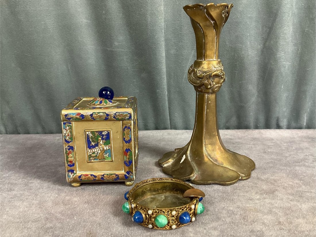 1930's Asian Inspired Brass Lot: Enamel on brass tea caddy with blue glass bead on lid, four sided Asian motif, footed, and stamped China on bottom. Art Nouveau style brass candle holder with dragon around the middle. Brass filigree 