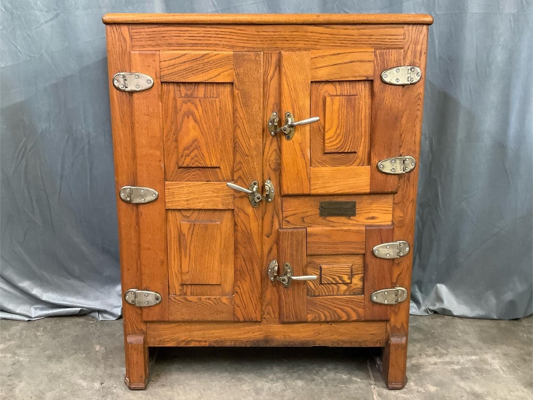 Antique Ice Chest: 1930s oak three door ice chest with original makers plate, Gomprecht and Benesch Baltimore, MD. Original hardware and wire shelves. Marked on back with patent dates. Damaged on top. Measures 33.75 inc