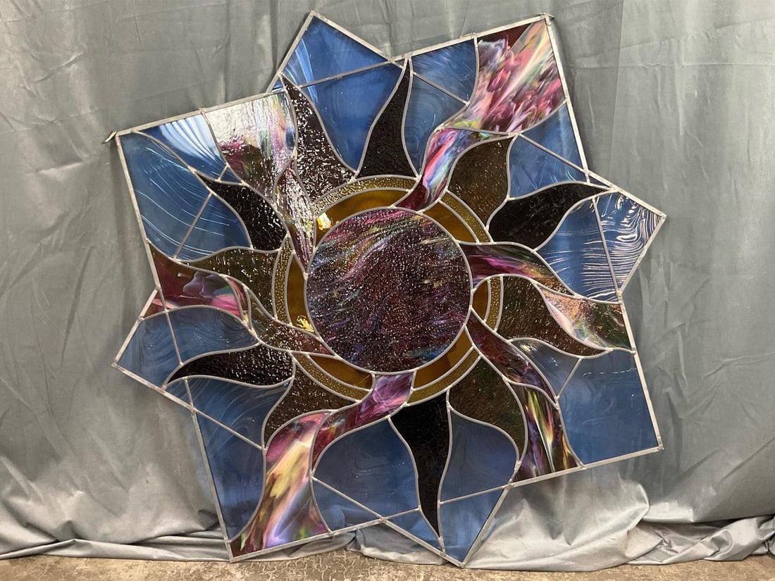 Large Celestial Stained Glass Hanger: Vintage leaded glass sunburst stained glass piece, Titled The Son's Heavenly Light and signed AY, MWM, RW. Glass pieces are secure in frame but there are several cracks to the bottom left side. Measur