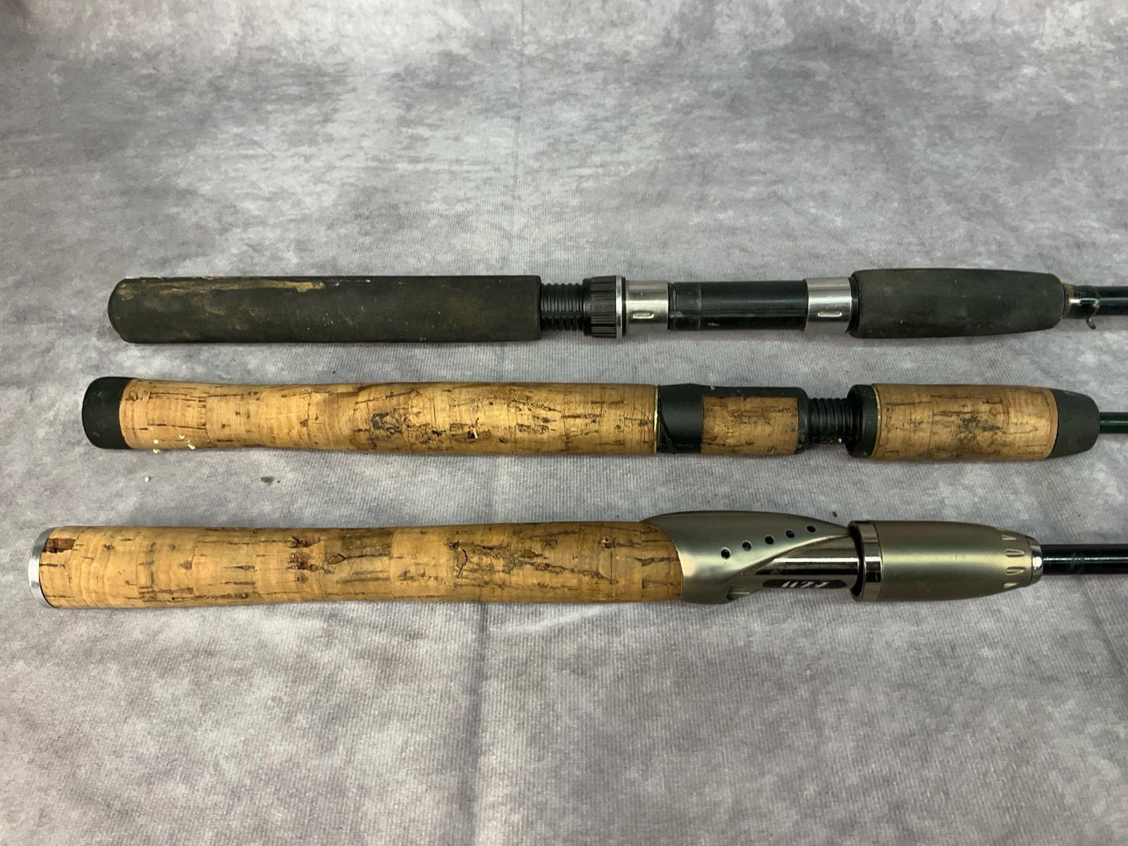 Three Fishing Rods: Included in this lot are three fishing rods in fair to good usable condition: Rhino tough glow tip ZRS662M 6‘6“ medium 8 to 14 pound line 1/8 to 5/8 oz Lure Made in China KJ1. Cabela's classic gra