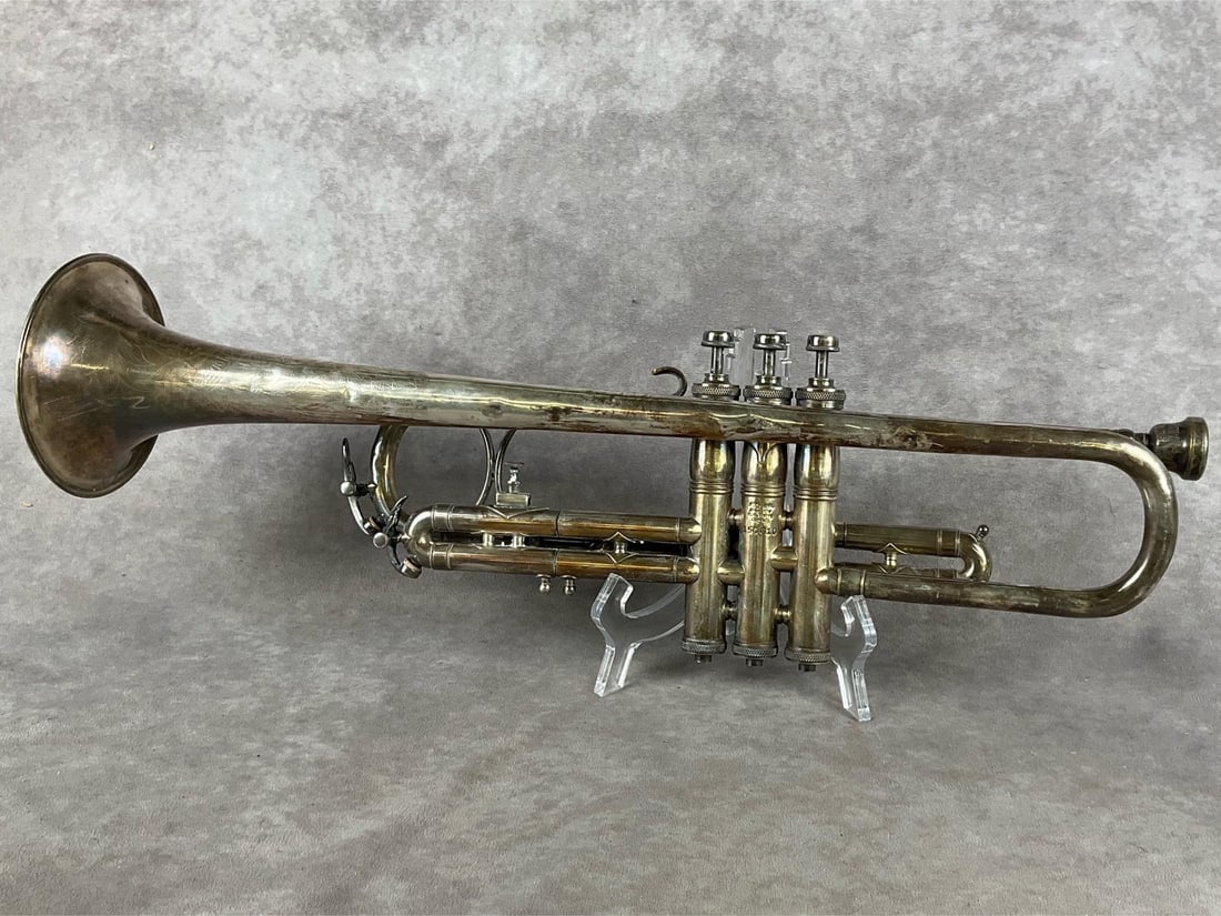 H.N. White “King" Trumpet: Liberty King Trumpet. Believed to be from the mid 1920s. Made in Cleveland. Fair condition, with dents, tarnish and scratches. Measures 5 inches wide x 20 inches tall.