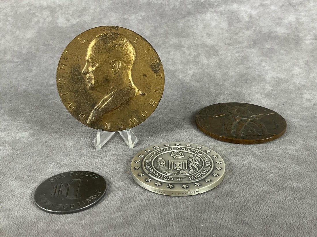 Relic Coins: Group of four. 1953 Eisenhower bronze inaugural coin, City of Chicago medal, one dollar non-negotiable coin, American Legion School Award medal. All are in fair to good condition with mild corrosion a