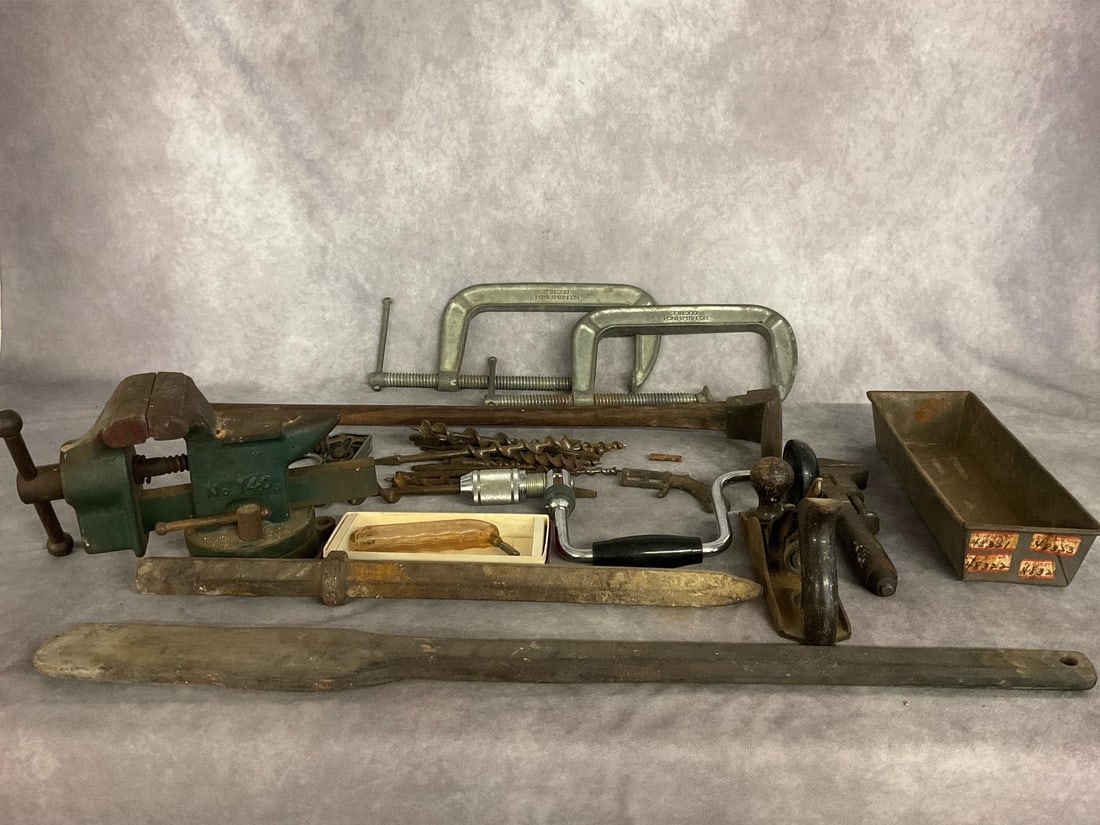 Antique & Vintage Tools: Large lot of hand tools, including foot adze, apple butter paddle, a bench vice, hand planer, adjustable wrench and more. All items have rust and wear. Foot adze measures 30 inches long. Very heavy it