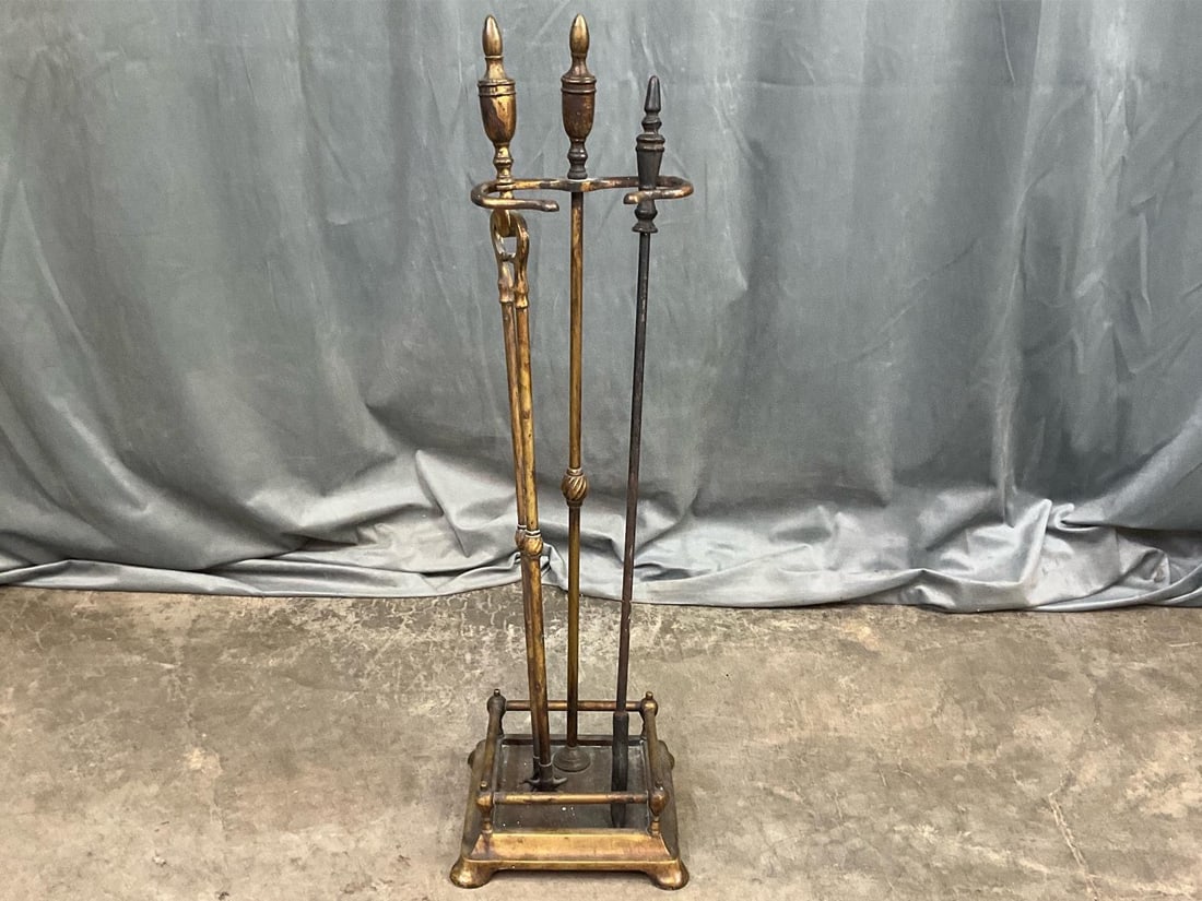 Vintage Brass Fireplace Tools with Stand: Set of two fireplace tools with stand. Has verdigris throughout and shows signs of use. Measures 30 inches tall.