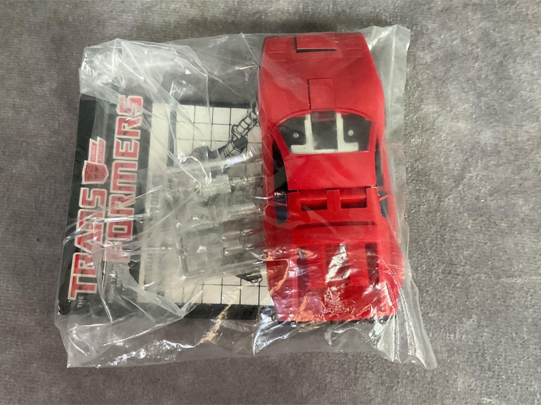 Transformers G1 Autobot Omnibot Overdrive: 1984 mail away piece. Includes car, label sheet, instruction booklet, and additional parts, all unused. Package appears sealed by tape. Very good condition. Rare find. Car measures 4 inches long x 1.5