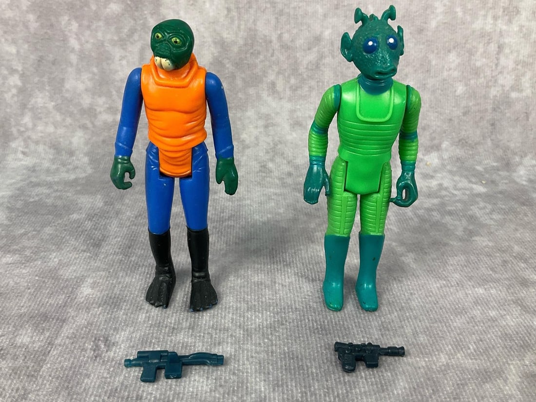 1978 Star Wars Figures: Lot of two made by GMFGI in Hong Kong. Greedo complete with gun, paint wear to boots. Ponda Baba Walrus Man complete with gun, wear to paint on feet and mouth. Each figure measures 3.75 inches tall.