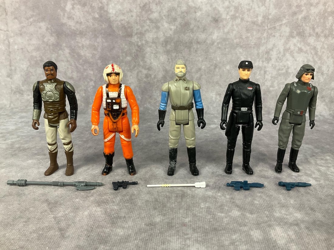 1970's & 1980's Star Wars Action Figures: Lot of five made by GMFGI and LFL in Honk Kong. 1982 Lando Calrissian in Skiff Guard disguise complete with weapon. 1978 Luke Skywalker X Wing pilot complete with gun, paint wear throughout. 1980 Impe