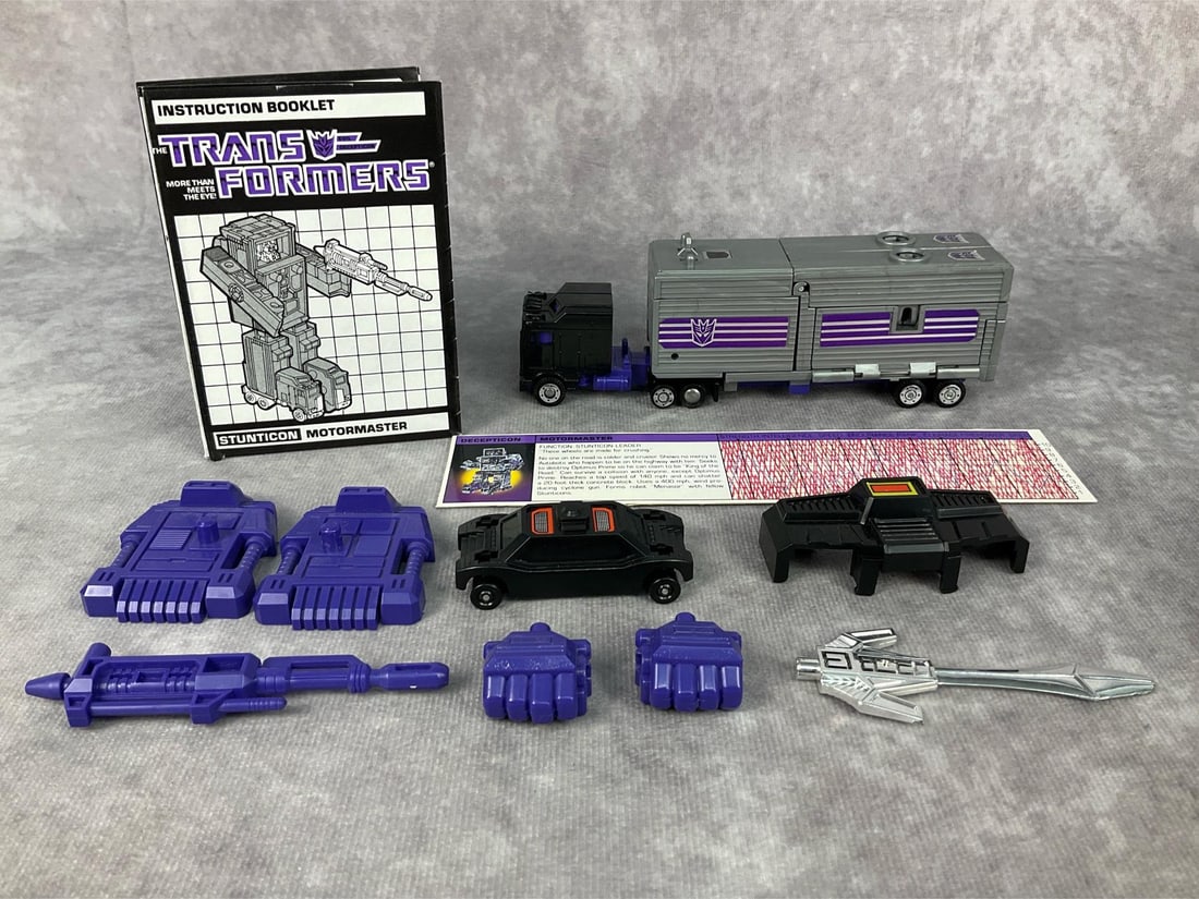 1985 Motormaster Transformer: Made by Hasbro in Japan. Includes instruction booklet, tech spec card, accessories, and weapons. Missing decoder, Menasor robot head. Good condition but does have minor wear to decals and scratches to