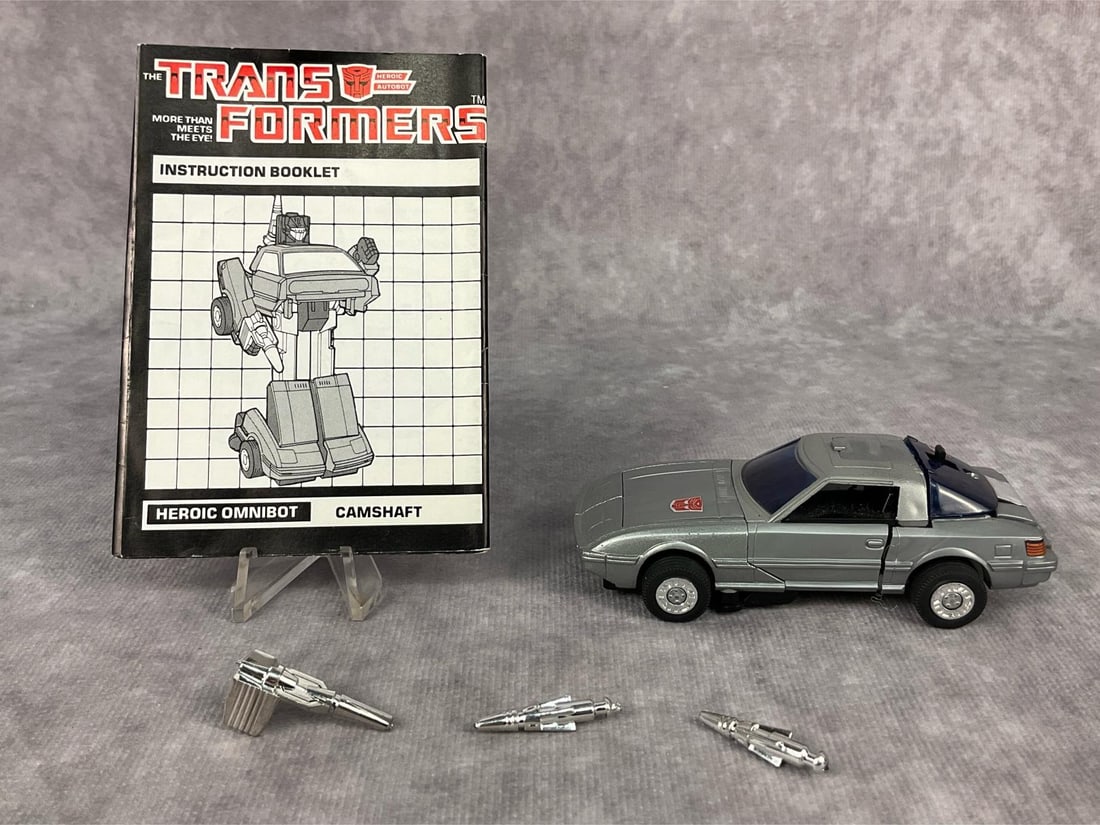 1984 Camshaft Transformer: Made by Hasbro in Japan. Includes instruction booklet and weapons. Missing decoder and tech spec card. Good condition but does have minor wear to decals. Transformer measures 3.75 inches long x 1.75 x