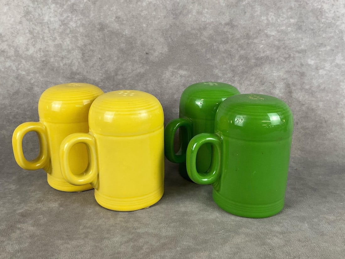 Fiestaware Salt & Pepper Shakers: Two sets. Sunflower yellow and meadow green, both sets are in good condition and marked on bottom. Both measure 5 inches wide x 5 inches tall.