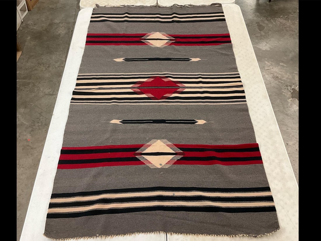 Chimayo Wool Blanket: Vintage handwoven wool blanket. Missing fringe, patched holes in center, and coming unraveled at one end. Measures 49 inches wide x 7 feet long.