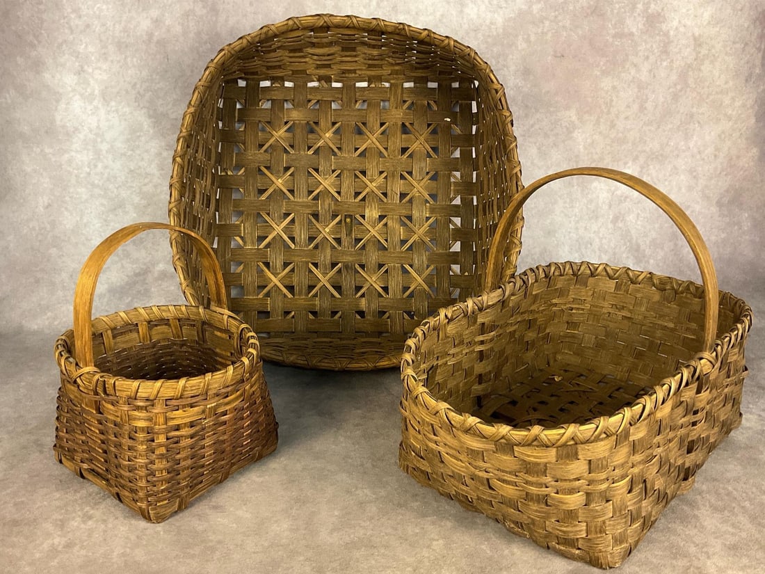 Decorative Baskets: Lot of three baskets in good condition. The largest measures 19 inches long x 19 inches wide x 6 inches tall.