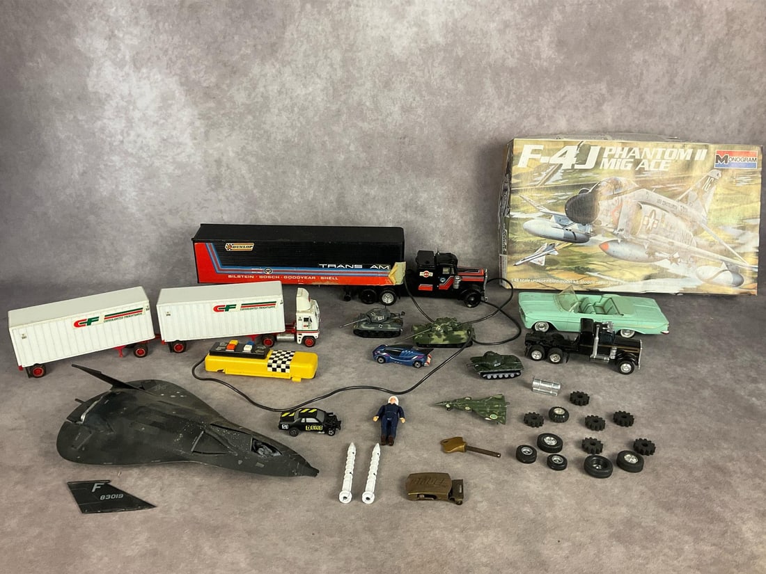 Collection of Models: Lot includes 1985 F-4J Phantom II MiG Ace model kit that appears complete and unassembled but has been partially painted, a remote controlled Trans Am Heavy Hauler in poor condition, a incomplete mode