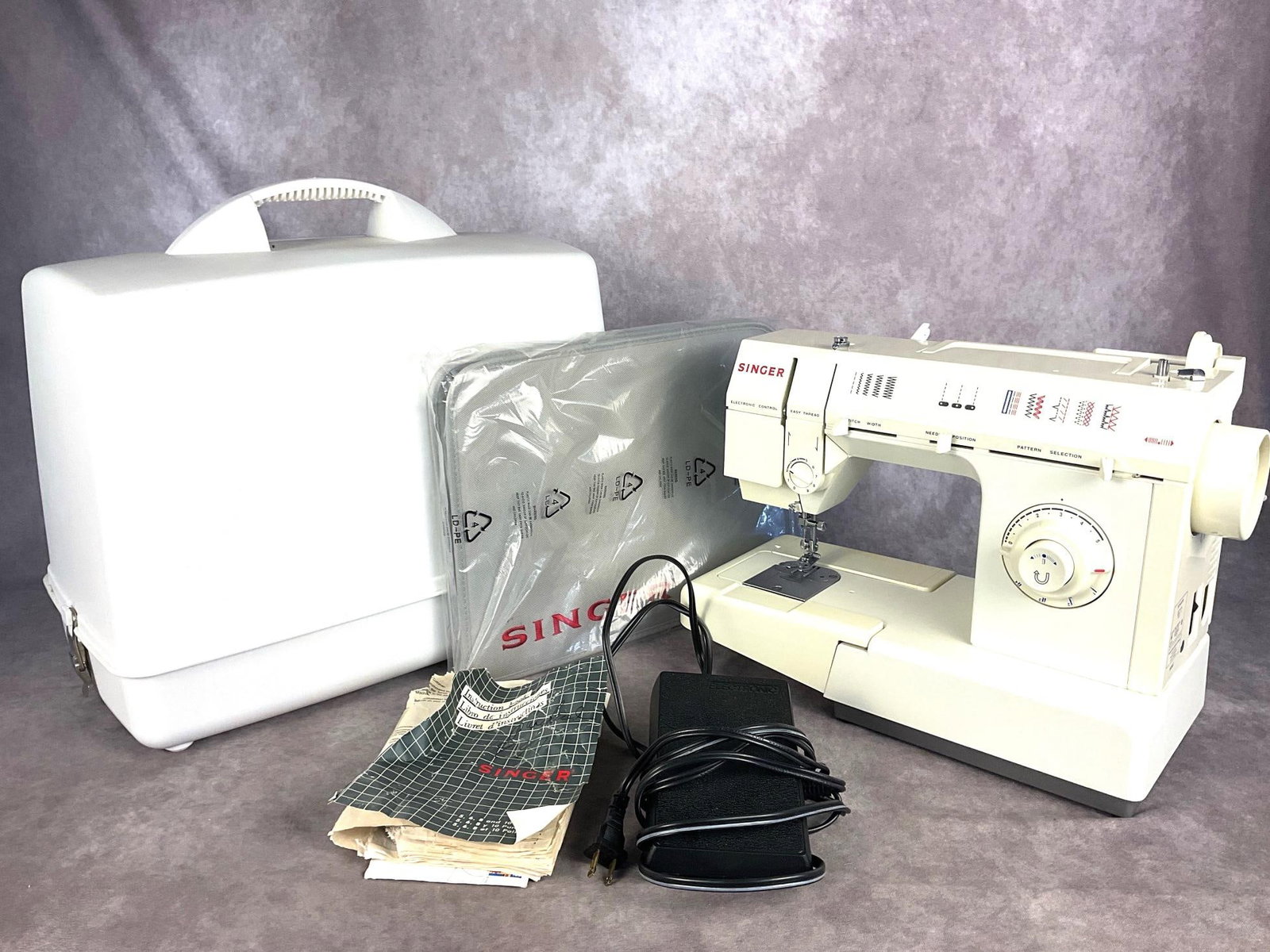 Singer Sewing Machine: 1997 Singer 5830c.Powers on. This sewing machine appears complete, is in good condition. Owners manual is in poor condition. Carrying case measures 19 inches long x 11 inches wide x 17 inches tall.