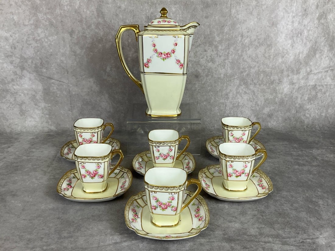 Nippon Chocolate Set: Early 1900s Morimura Nippon chocolate pot with six tea cups and saucers. Marked on bottom. Good condition, but one cup has two chips. Minor wear to gold gilt paint in spots. Chocolate pot measures 7 i