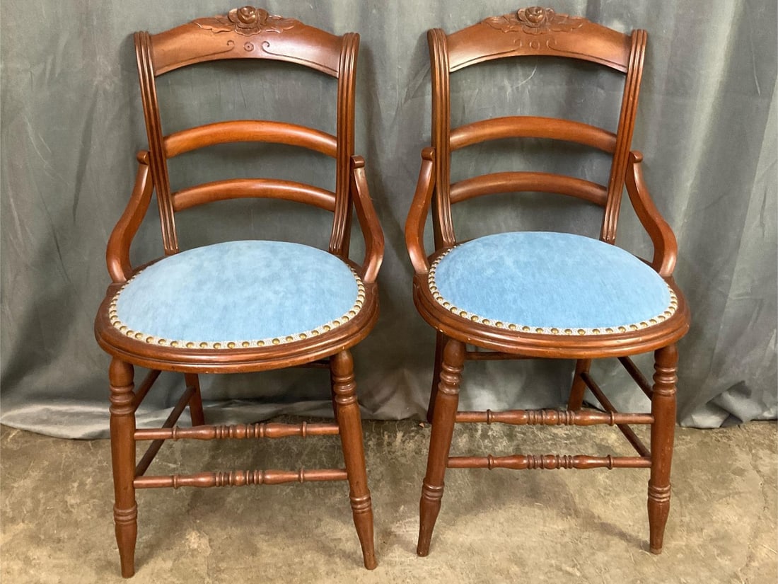 Eastlake Parlor Chairs: Two Victorian walnut Eastlake parlor or side chairs. Carved rose design at top and blue velvet bottoms. Good condition. Each measures 18 inches wide x 16 x 33 inches tall.