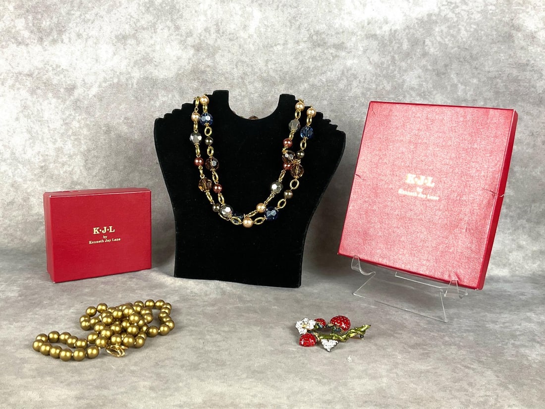Kenneth Jay Lane Costume Jewelry: Two necklaces and strawberry brooch, marked KJL. All in good condition. Bronze beaded necklace measures 16 inches long.