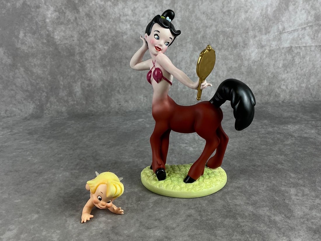 Disneys Fantasia Figures: 1998 Walt Disney Classics Collection figures Cupid and Romantic Reflections. Both are complete with COA and boxes. Both boxes are in fair condition. The larger box measures 10 inches long x 8 inches w
