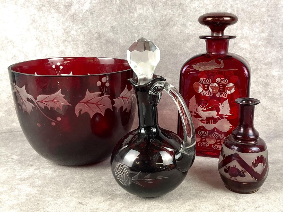 Ruby Red Cut to Clear Glass Pieces: One holly dish, one cruet, one decanter and bud vase. Fair to good condition, bud vase has a chip on the rim and decanter has adhesive residue. Decanter measures 4 inches wide x 8 inches tall, with st