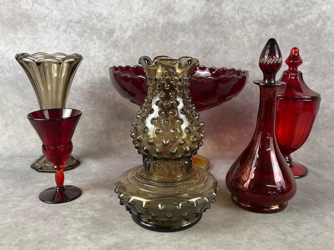 Smokey Grey & Red Art Glass: Group of six pieces. One Amberina compote, one red glass candy jar, one handblown burgundy decanter, one small red glass cup, one Imperial glass hobnail vase, and one grey vase. All are in good condit