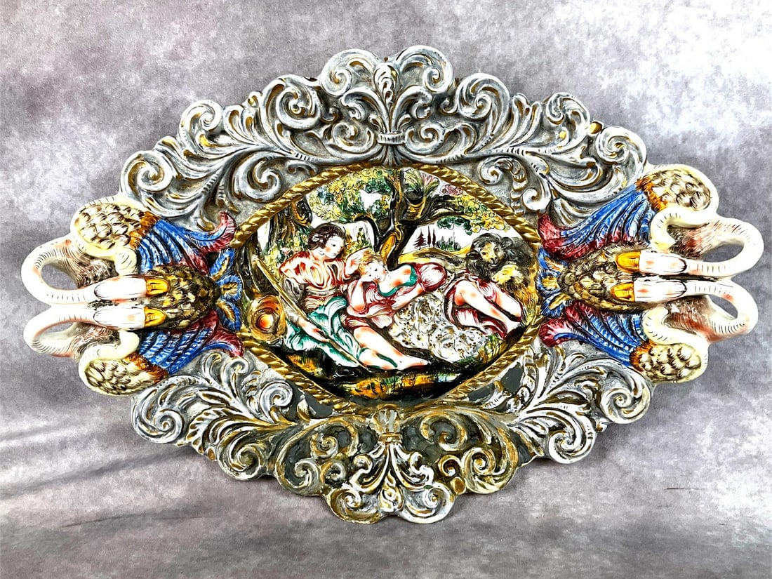 Italian Porcelain Capodimonte Platter: Hand painted and signed on the back. Some paint loss on the bottom front, but otherwise good condition. Measures 23 inches wide x 15 inches tall.