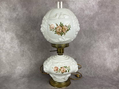 Gone With The Wind Lamp: Vintage milk glass lamp and globe with brass base. Embossed lion heads and transferware flowers. Good condition with wear to brass base. Tested and working, bottom portion is not meant to light up. Me