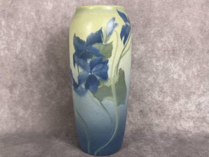 Rookwood Pottery Vase: 1907 Rookwood Pottery vase. Marked with fourteen flame R with Roman Numerals VII. Vellum glaze, blue floral design. Crazing throughout. Measures 2.25 inches wide at base x 7.25 inches tall.