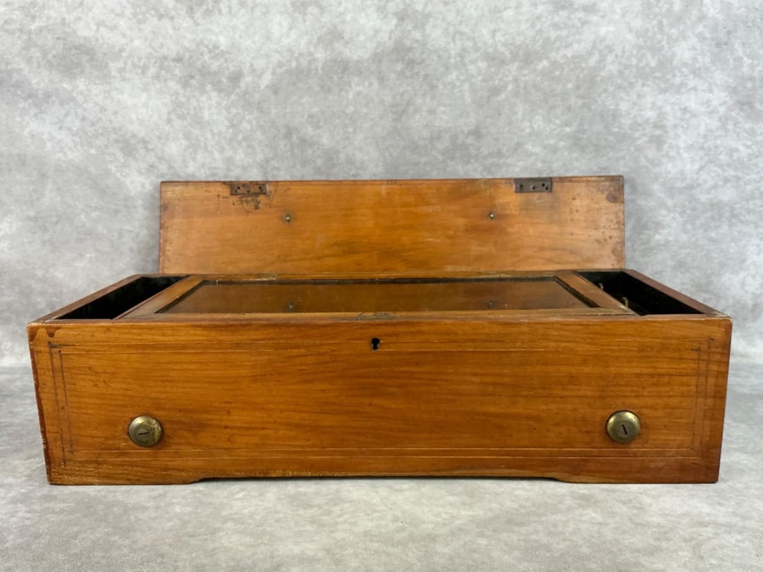 Swiss Cylinder Music Box: Mid to late 1800s, contains a note that states it was brought from Bleicherode, Germany by Thomas Langford. Plays the tunes Blue Danube Waltz, Das Rhine, and De Lovalie. Incased in original solid oak