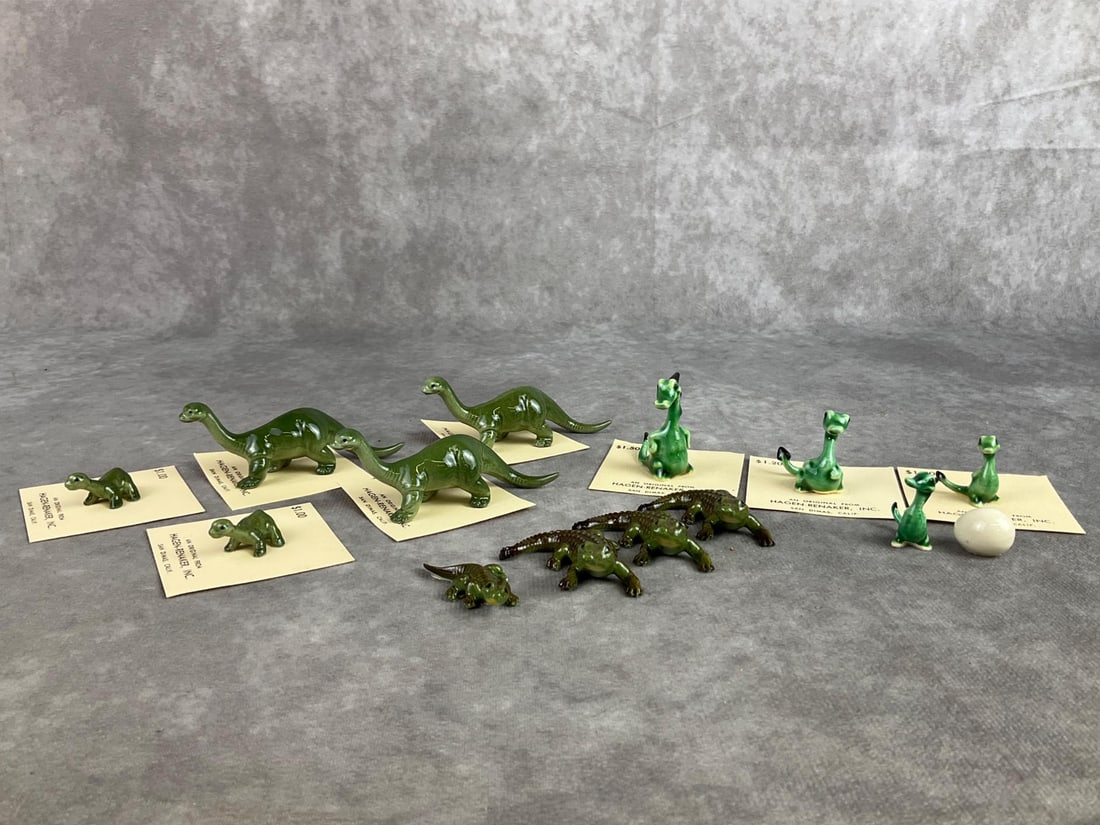 Hagen-Renaker Lot: Lot of fourteen Hagen Renaker miniature figures including dragons, dinosaurs and alligators. All in good condition. Large dinosaur measures 3.25 inches wide x 1.5 inches tall.