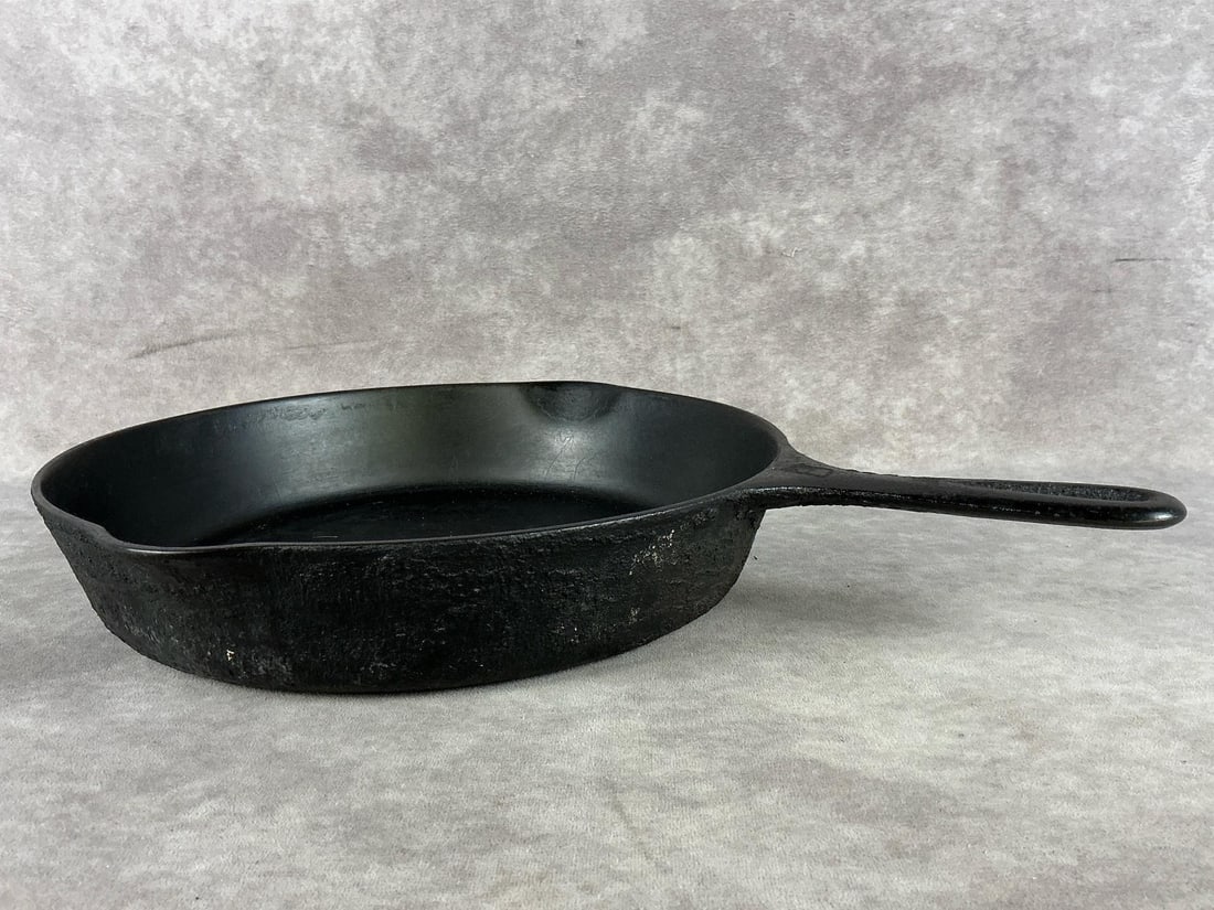 Griswold Cast Iron Skillet: No.8 cast iron skillet. Some rust present and appears repainted, but overall good used condition. Measures 10 inches in diameter.