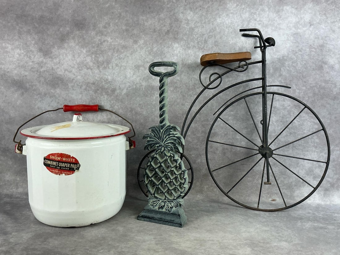 Vintage to Modern Home Finds: High wheel bicycle, Virginia Metalcrafters Williamsburg cast pineapple doorstop, and a Snow White diaper pail. Items are in fair to good condition. Bicycle measures 9.5 inches wide x 3.5 x 19.5 inches